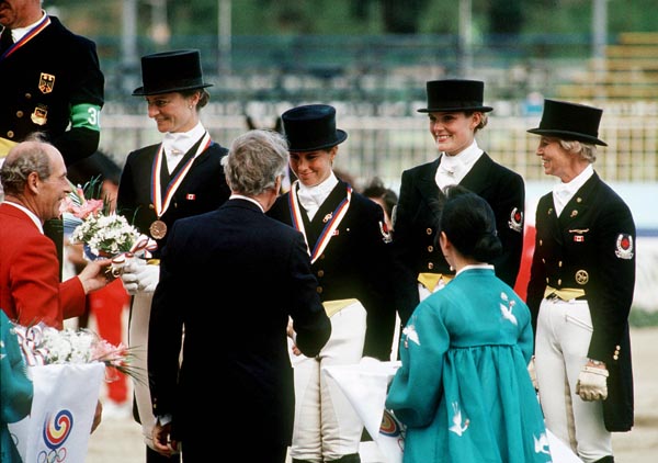 (Left to right) Canada's Gina Smith, Cindy Ishoy, Ashley Nicoll and Eva-Maria Pracht celebrate their bronze medal win in the equestrian-dressage event at the 1988 Olympic games in Seoul. (CP PHOTO/ COA/ C. McNeil)