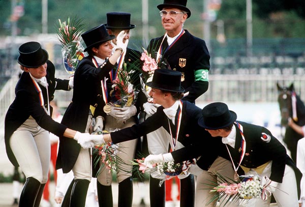 (Right to left) Canada's Cindy Ishoy, and Gina Smith celebrate their bronze medal win with gold medal winners Team France in the equestrian-dressage event at the 1988 Olympic games in Seoul. (CP PHOTO/ COA/ C. McNeil)