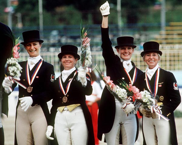 (Left to right) Canada's Gina Smith, Cindy Ishoy, Ashley Nicoll and Eva-Maria Pracht celebrate their bronze medal win in the equestrian-dressage event at the 1988 Olympic games in Seoul. (CP PHOTO/ COA/ C. McNeil)
