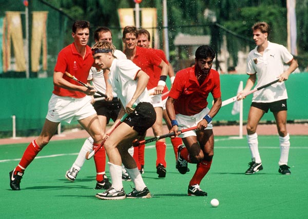 Canada's Hargurnek Sandhu (infront), Ian Bird (left) and Pat Burrows play field hockey at the 1988 Seoul Olympic Games. (CP Photo/ COA/ T. Grant)