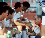 Canada's Trevor Clarke, the men's field hockey team coach, discusses with players at the 1988 Seoul Olympic Games. (CP Photo/ COA/ T. Grant)