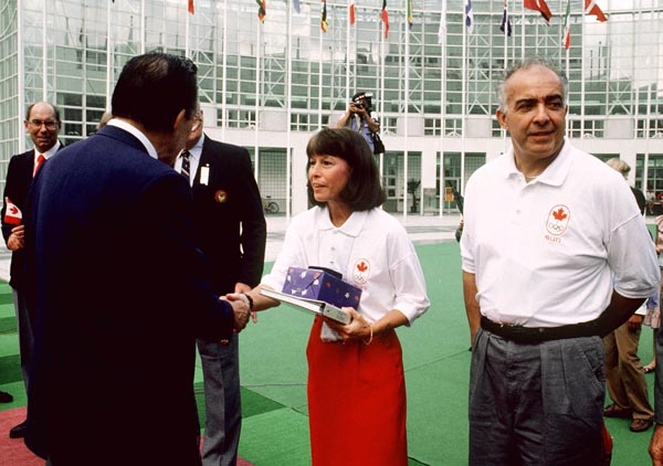 Canada's Carol Anne Letheren (centre) and Yves Tetreault (right) during the flag raising ceremonies at the 1988 Olympic games in Seoul. (CP PHOTO/ COA/ Cromby McNeil)