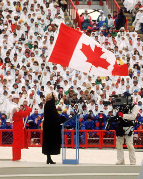 Canada's Brian Orser carries the Canadian flag during the opening ceremonies of the 1988 Winter Olympics in Calgary. (CP PHOTO/COA)