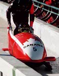 (From left to right) Canada's Greg Haydenluck, Cal Langford, Kevin Tyler and Lloyd Guss compete in the four man bobsleigh event at the 1988 Calgary Winter Olympics. (CP PHOTO/ COA/ T. O'lett)