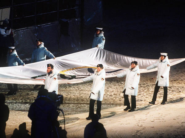 Participants carry the Olympic flag during closing ceremonies at the 1988 Winter Olympics in Calgary. (CP PHOTO/COA/ F.S.Grant)