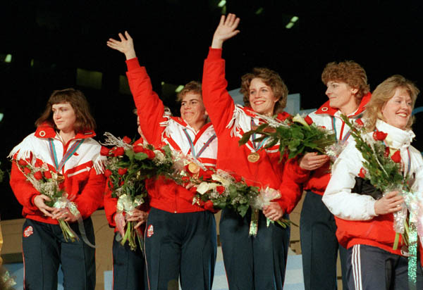 (From left to right) Canada's Linda Moore, Lindsay Sparkes (hidden), Debbie Jones, Penny Ryan and Patti Vandekerckhove celebrate their gold medal win in the women's curling event at the 1988 Calgary Olympic winter Games. (CP PHOTO/COA/Ted Grant)