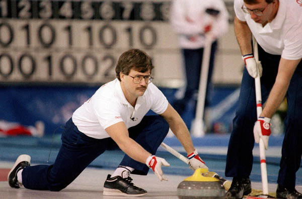 Canada's Edward Lukowich (left) and Neil Houston compete in the curling event at the 1988 Calgary Olympic winter Games. (CP PHOTO/COA/Ted Grant)