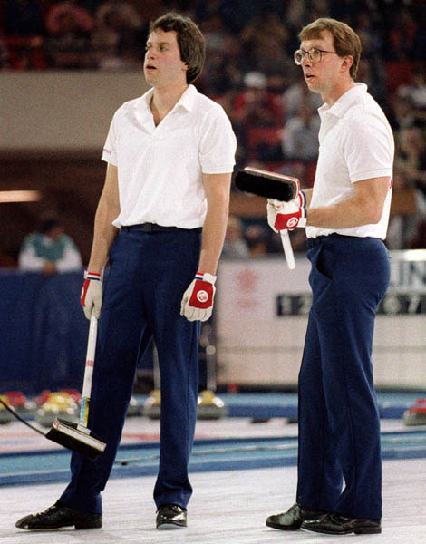 Canada's Brent Syme (left) and Neil Houston compete in the curling event at the 1988 Calgary Olympic winter Games. (CP PHOTO/COA/Ted Grant)