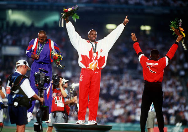 Canada's Donovan Bailey (centre) celebrates the gold medal won in the men's 100m at the 1996 Atlanta Summer Olympic Games. (CP PHOTO/COA/Claus Andersen)