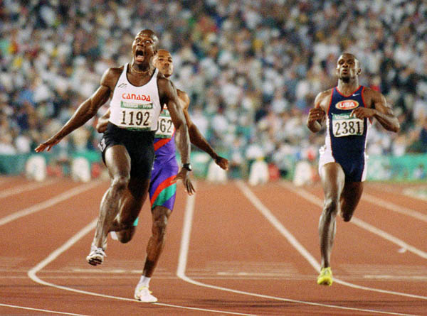 Canada's Donovan Bailey (left) reacts after crossing the finish line in the men's 100m event at the 1996 Atlanta Summer Olympic Games. (CP PHOTO/COA/Claus Andersen)