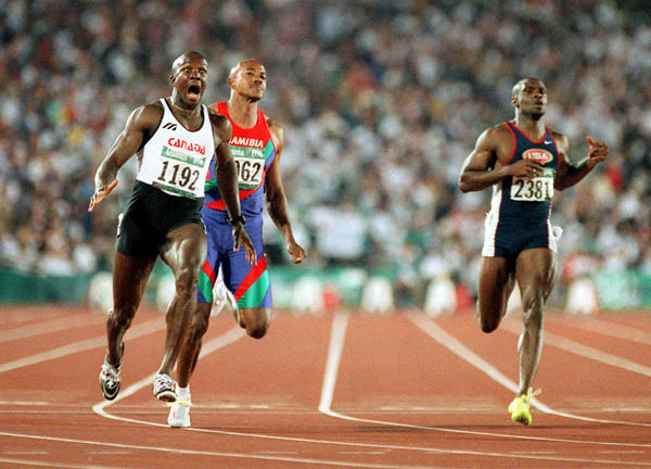 Canada's Donovan Bailey (left) reacts after crossing the finish line in the men's 100m event at the 1996 Atlanta Summer Olympic Games. (CP PHOTO/COA/Claus Andersen)