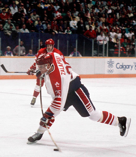 Canada's Zarley Zalapski (#25) participates in the hockey event at the 1988 Winter Olympics in Calgary. (CP PHOTO/ COA/ S.Grant)