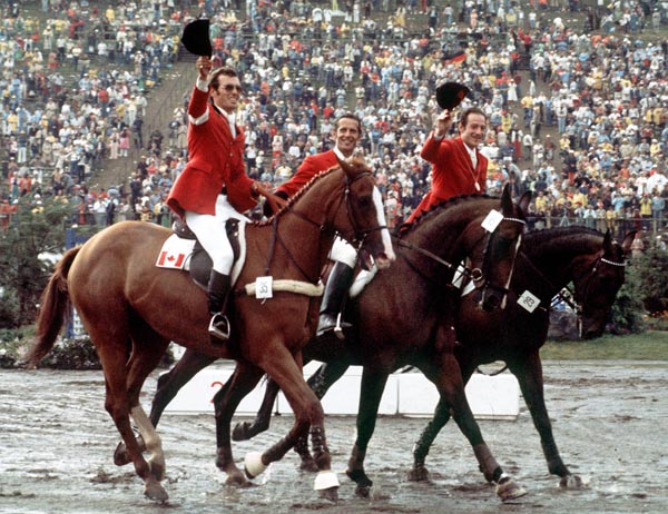 Canada's Michel Vaillancourt (left) waves to the crowd atop Branch County in an equestrian event at the 1976 Montreal Olympic games. (CP PHOTO/ COA/RW)