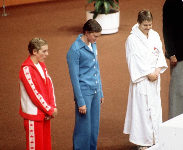 Canada's Cheryl Gibson (left) and Becky Smith (right) celebrate their respective silver and bronze medals wins in the swimming event at the 1976 Olympic games in Montreal. (CP PHOTO/ COA/RW)