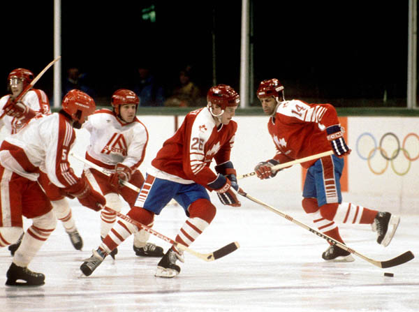 Canada's Patrick Flatley (26) and Darren Lowe (14) compete during hockey action against Austria at the 1984 Winter Olympics in Sarajevo. (CP PHOTO/ COA/ O. Bierwagon)