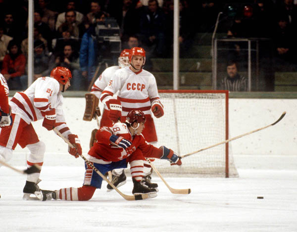Canada's Russ Courtnall (centre) reaches for the puck during hockey action against the USSR at the 1984 Winter Olympics in Sarajevo. (CP PHOTO/ COA/O. Bierwagon )
