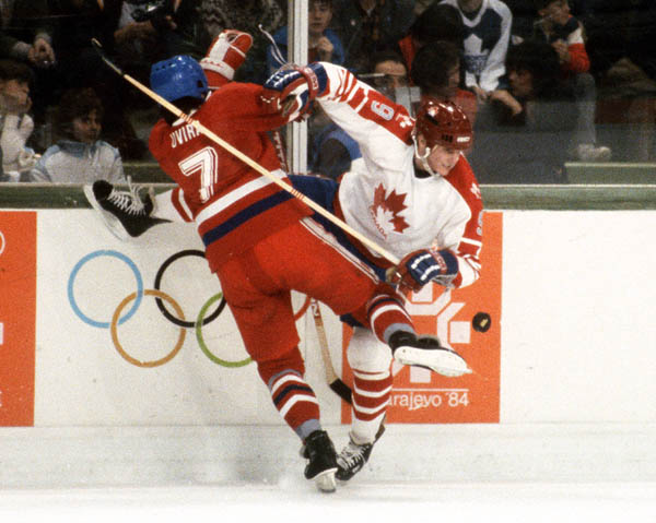 Canada's James Patrick (right) collides with an opponent during hockey action against Czechoslovakia at the 1984 Winter Olympics in Sarajevo. (CP PHOTO/ COA/ O. Bierwagon)