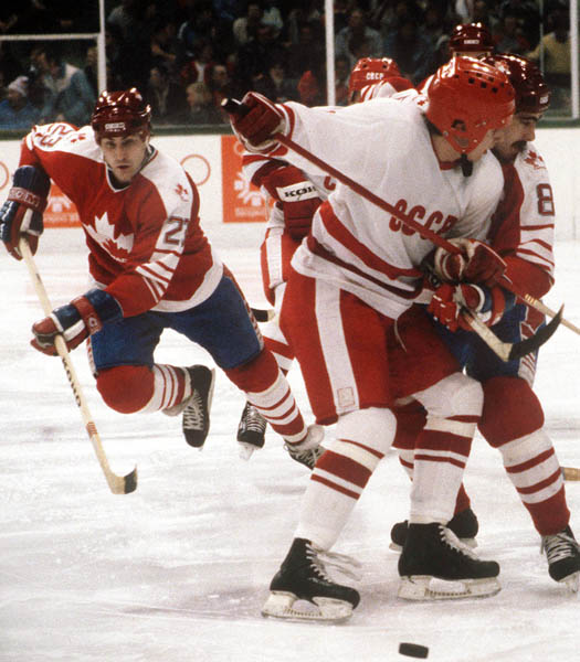 Canada's Dave Donnelly (left) comes to the aid of tangled-up teammate Dave Tippett (8) during  hockey action against the USSR at the 1984 Winter Olympics in Sarajevo. (CP PHOTO/ COA/O. Bierwagon )