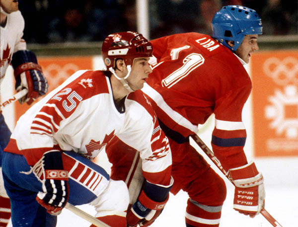 Canada's Bruce Driver (left) holds Igor Liba of Czechoslovakia during hockey action at the 1984 Winter Olympics in Sarajevo. (CP PHOTO/ COA/O. Bierwagon )