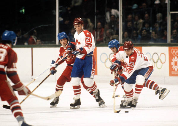 Canada's Dave Donnelly (right) handles the puck as kirk Muller (centre) holds off the Czechoslovakia opponent during hockey action at the 1984 Winter Olympics in Sarajevo. (CP PHOTO/ COA/O. Bierwagon )