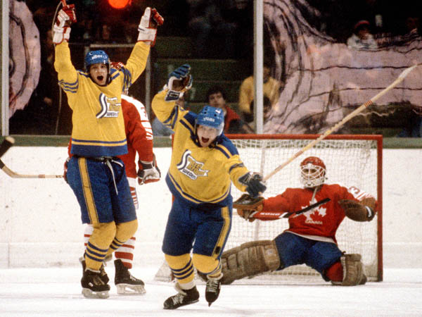 Team Sweden celebrates a goal against Canada's Mario Gosselin (right) during hockey action at the 1984 Winter Olympics in Sarajevo. (CP PHOTO/ COA/O. Bierwagon )