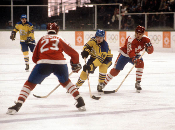 Canada's Dave Donnelly (#23) and Robin Bartel (#2) defend their territory during hockey action against Sweden at the 1984 Winter Olympics in Sarajevo. (CP PHOTO/ COA/O. Bierwagon )