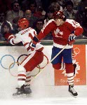 Russ Courtnall (right) avoids a check from Zenetoula Bilyatletdinov of the USSR during hockey action at the 1984 Winter Olympics in Sarajevo. (CP PHOTO/ COA/O. Bierwagon )