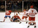 Canada's Robin Bartel (bottom) and Bruce Driver gang up on Edward Olczyk of the United States as Mario Gosselin (goalie) looks on during hockey action at the 1984 Winter Olympics in Sarajevo. (CP PHOTO/ COA/O. Bierwagon )