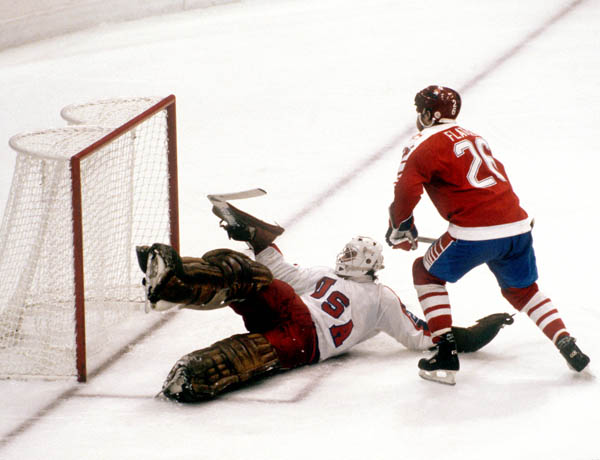 Canada's Patrick Flatley (right) shoots on goal during hockey action against the United States at the 1984 Winter Olympics in Sarajevo. (CP PHOTO/ COA/O. Bierwagon )