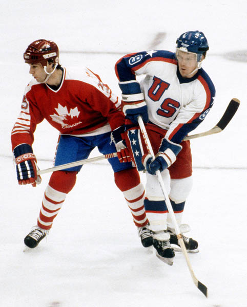 Canada's Bruce Driver (left) competes in hockey action against the United States at the 1984 Winter Olympics in Sarajevo. (CP PHOTO/ COA/O. Bierwagon )