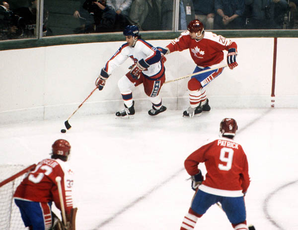 Canada's Mario Gosselin (goalie), Carey Wilson (20) and James Patrick (9) compete in hockey action against the United States at the 1984 Winter Olympics in Sarajevo. (CP PHOTO/ COA/O. Bierwagon )