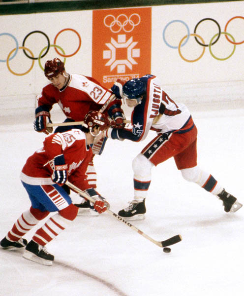 Canada's Dave Donnelly (23) and Bruce Driver (25) compet in hockey action against the United States at the 1984 Winter Olympics in Sarajevo. (CP PHOTO/ COA/O. Bierwagon )