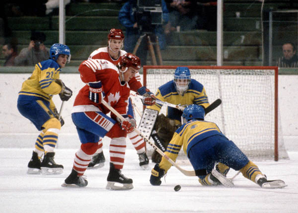 Canada's Craig Redmond (foreground) vies for position during  hockey action against Sweden at the 1984 Winter Olympics in Sarajevo. (CP PHOTO/ COA/O. Bierwagon )