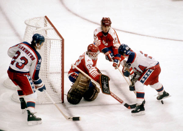 Canada's Bruce Driver and Mario Gosselin (goalie) defend the goal during hockey action against the United States at the 1984 Winter Olympics in Sarajevo. (CP PHOTO/ COA/O. Bierwagon )