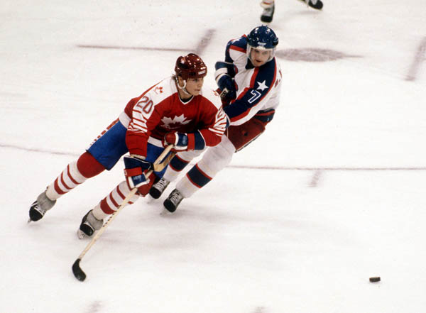 Canada's Carey Wilson (left) competes in hockey action against the United States at the 1984 Winter Olympics in Sarajevo. (CP PHOTO/ COA/O. Bierwagon )
