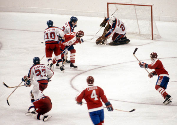 Canada's Kevin Dineen (centre) takes a shot during  hockey action against the United States at the 1984 Winter Olympics in Sarajevo. (CP PHOTO/ COA/O. Bierwagon )