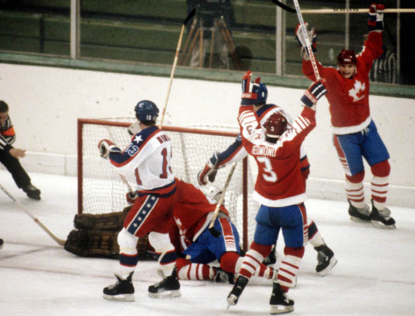 Team Canada, including Craig Redmond (3), celebrate a goal during hockey action against the United States at the 1984 Winter Olympics in Sarajevo. (CP PHOTO/ COA/O. Bierwagon )