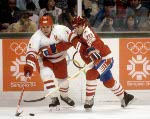 Canada's Patrick Flatley (in front) goes around the net during hockey action against the United States at the 1984 Winter Olympics in Sarajevo. (CP PHOTO/ COA/O. Bierwagon )