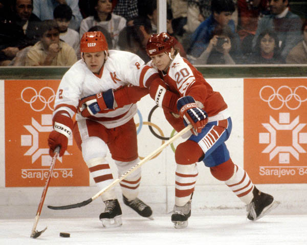 Canada's Carey Wilson (right) holds of USSR's captain Vyacheslav Fetisov during hockey action at the 1984 Winter Olympics in Sarajevo. (CP PHOTO/ COA/O. Bierwagon )