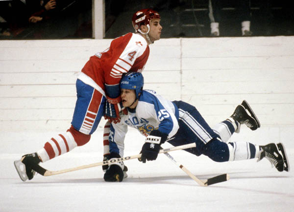 Canada's Doug Lidster (4) collides with Raimo Summanen of Finland during hockey action at the 1984 Winter Olympics in Sarajevo. (CP PHOTO/ COA/O. Bierwagon )