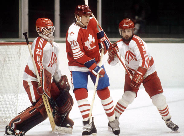 Canada's Carey Wilson (centre) competes in hockey action against Austria at the 1984 Winter Olympics in Sarajevo. (CP PHOTO/ COA/O. Bierwagon )