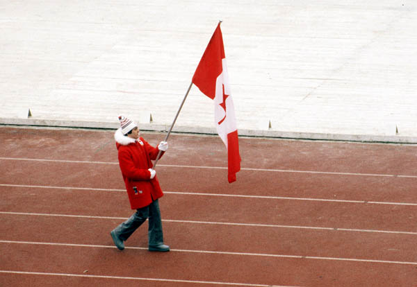 Canadian flag-bearer Gaetan Boucher leads Canadian athletes as they make their entrance during the opening ceremonies at the 1984 Winter Olympics in Sarajevo. (CP PHOTO/COA/J. Merrithew )