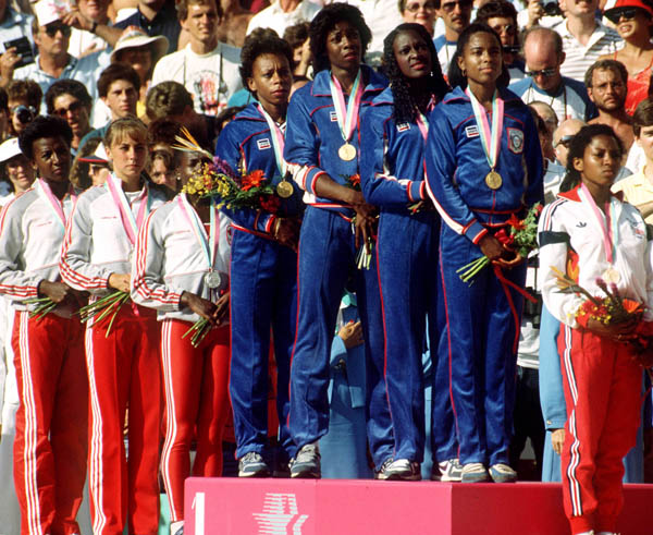Canada's women's relay team (left) celebrate their silver medal win in the 4x400m relay event at the 1984 Olympic games in Los Angeles. (CP PHOTO/ COA/Crombie McNeil)