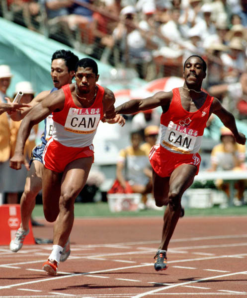 Canada's Desai Williams (right) hands off the baton to Sterling Hinds (left) during a relay race at the 1984 Olympic games in Los Angeles. (CP PHOTO/ COA/JM)