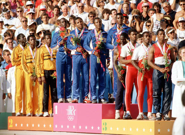 Canada's men's relay team (right) celebrates their bronze medal win in the 4x400m relay at the 1984 Olympic games in Los Angeles. (CP PHOTO/ COA/J. Merrithew)