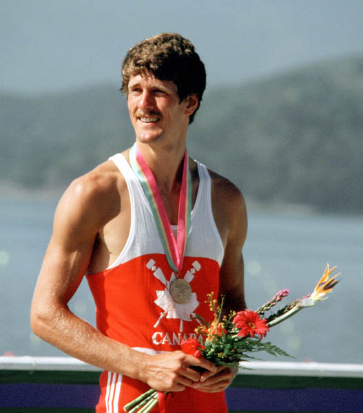Canada's Bob Mills celebrates a bronze medal win in the men's singles rowing event at the 1984 Olympic games in Los Angeles. (CP PHOTO/ COA/Ted Grant)