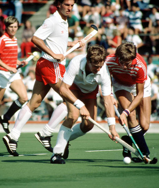 Canada's Pat Burrows and Ross Rutledge (white) play field hockey at the 1984 Los Angeles Olympic Games. (CP Photo/ COA/ Ted Grant)