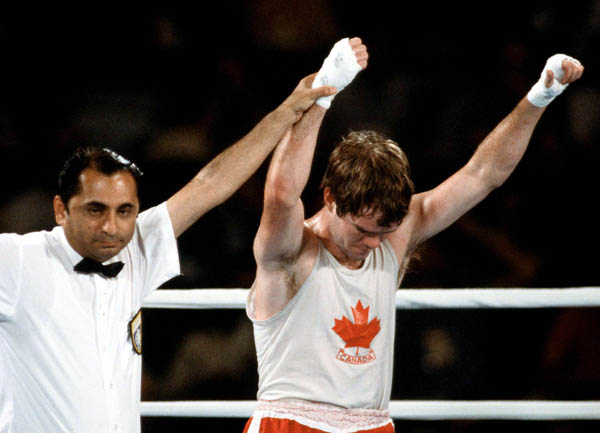 Canada's Shawn O'Sullivan (left) is declared the winner in a boxing match at the 1984 Olympic games in Los Angeles. (CP PHOTO/ COA/ Tim O'lett)