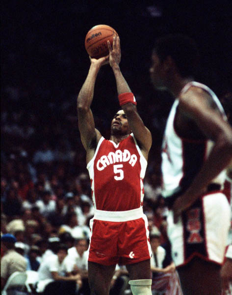 Canada's Tony Simms (5) makes a shot during basketball action at the 1984 Olympic Games in Los Angeles. (CP PHOTO/COA/J. Merrithew)