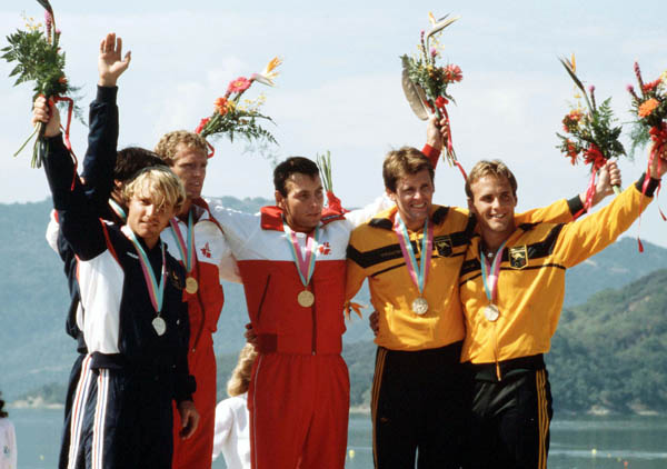 (Centre) Canada's Hugh Fisher and Alwyn Morris celebrate a gold medal win in the men's kayak K-2 event at the 1984 Olympic games in Los Angeles. (CP PHOTO/ COA/)